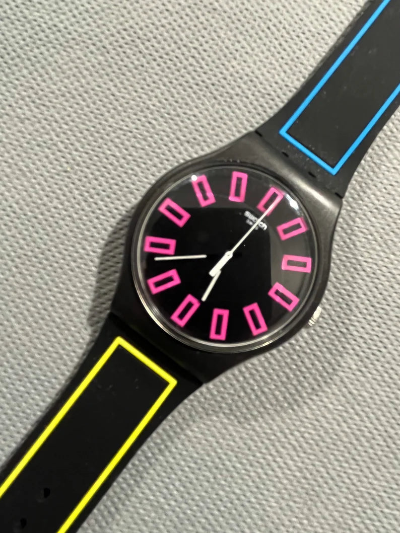 Swatch Watch called Around the Strap SUOB146 black, blue, pink and yellow neon 41mm face running with battery NEW condition in box