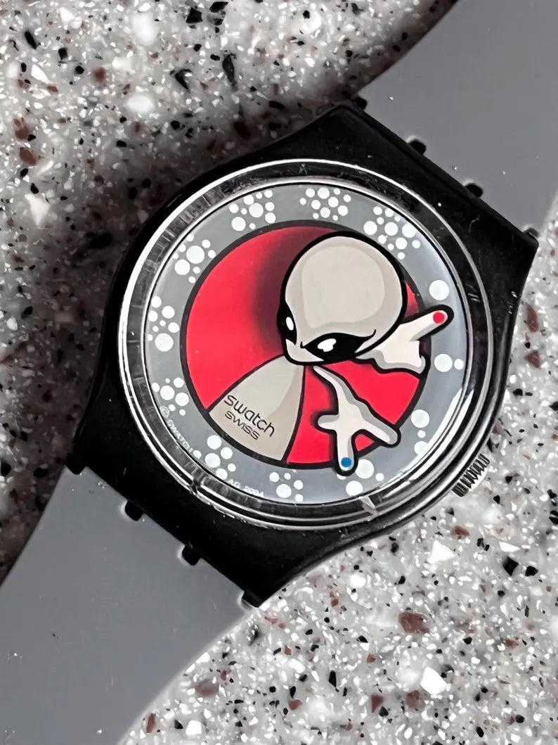 Vintage Pre owned good condition for age in box 34mm face running battery included replacement band called phone home alien swatch watch